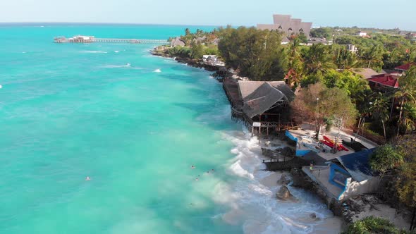Aerial Tropical Landscape of Zanzibar Waves Hit Reef on Hotels Coastline Palms alt
