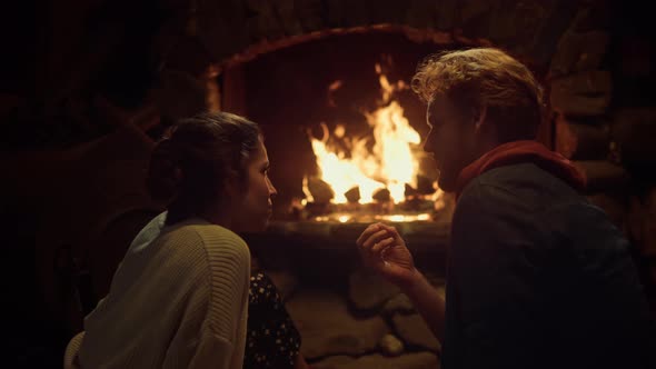 Couple Resting Together Fireplace in Comfort Wooden House alt