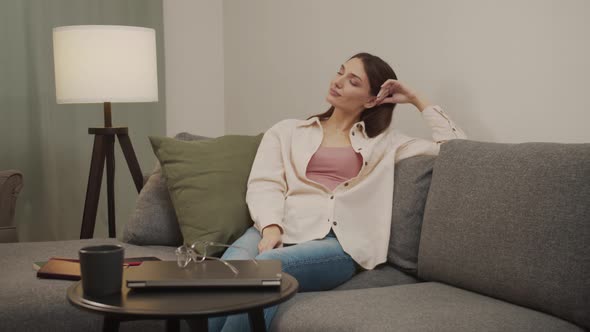 Beautiful Girl Takes Off Her Glasses Puts Them on the Table Massages Her Head and Takes a Nap