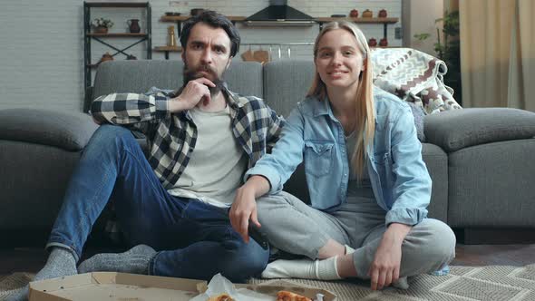 Young couple watching movie together