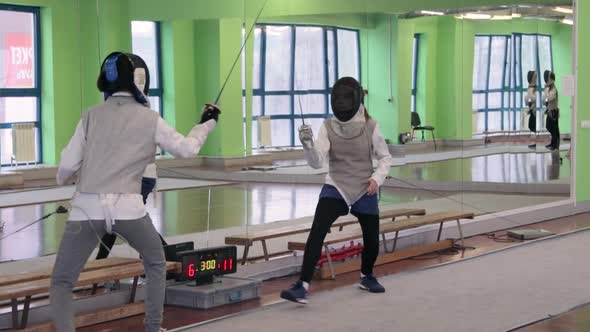 Teenagers practicing fencing at a fencing school