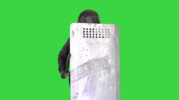 Riot Police Making Noise Hitting His Riot Shield with Baton on a Green Screen Chroma Key alt