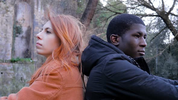 lovers Incommunicability concept.Mixed race couple after quarrel in the park alt