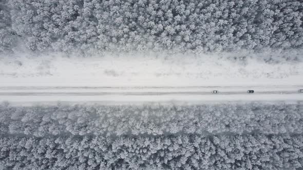 Aerial Top View From Drone Birds Eye View of Winter Landscape and Snowy Ice Road Car Moving on Area