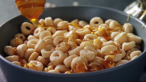 Honey pouring into a cereal bowl alt