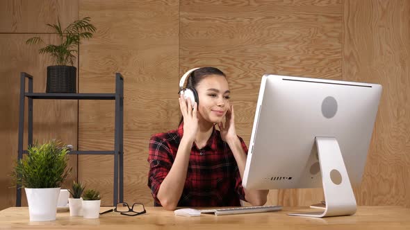 Cheerful Girl in Office Listening To Music in Headphones alt