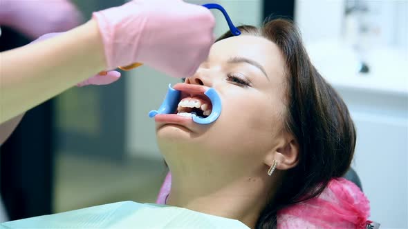 Dentist Prepares Patient For Teeth Whitening Procedure