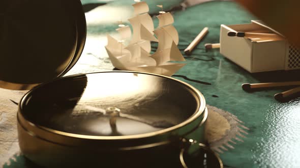 Tiny little paper ship navigating through a sea on an old treasure map. 4KHD alt