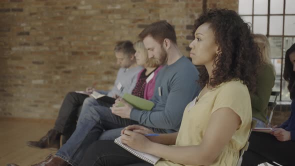 Group adults sitting and listening to speaker at event