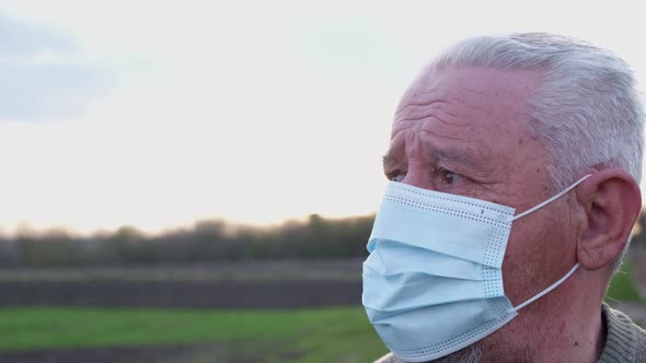 Close up portrait of a senior man in a mask. alt