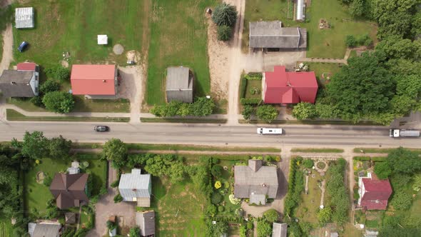 Birds eye shot tracking moving cars moving through small town