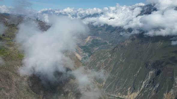 Drone flight in the Colca Canyon dawn with clouds and views towards the towns. alt