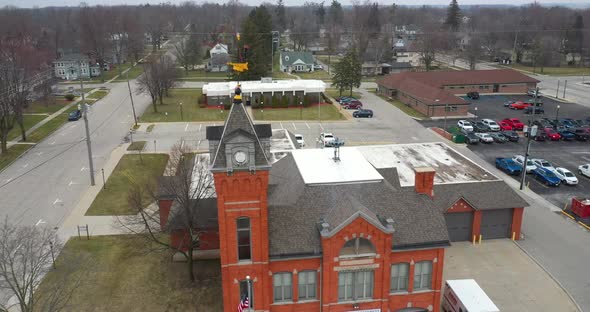 Antique fire station in Ithaca, Michigan with drone videoing down. alt