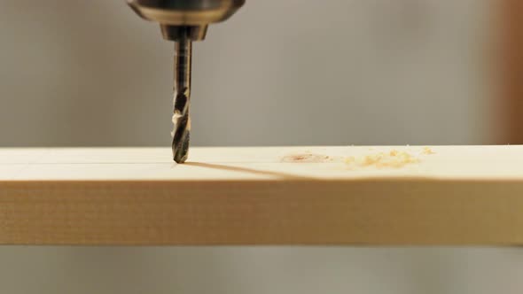 Twist Drill Drills Thru a Wooden Plank Closeup in Slomo