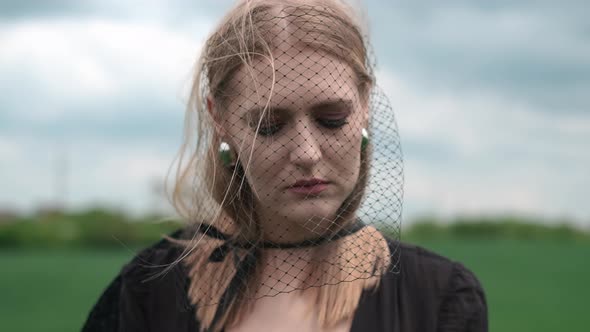 Girl In Black Dress Goes By The Field. alt