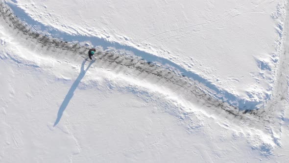 Woman is skating on frozen lake in winter alt