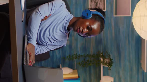 Vertical Video African American with Wireless Headphones Listening Online Courses alt