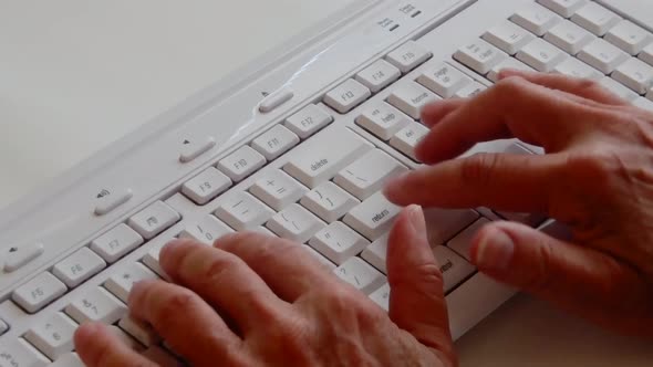 Busy hands working and typing on a computer keyboard. alt
