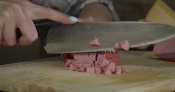 The Girl Cut Slices of Sausage Closeup