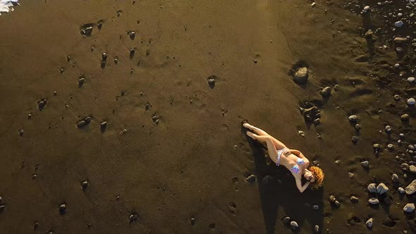 Attractive woman young people with bikini at the beach viewed from vertical top view