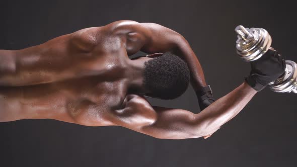 An Athletic AfricanAmerican in Good Athletic Shape is Engaged in Sports on an Isolated Dark alt