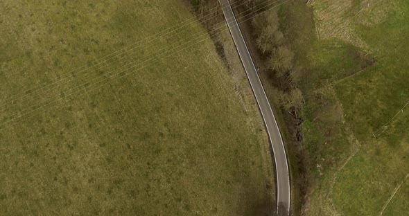 Drone flight over street and fields. alt