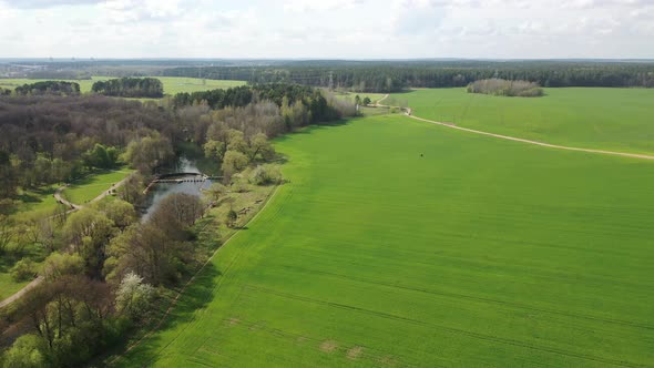 Slow Flight Over a Green Sown Field and a River alt