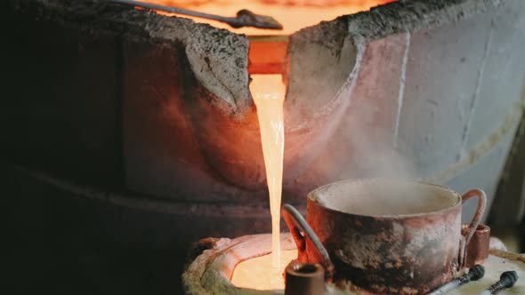 Workers Pour Hot Metal Into Molds alt