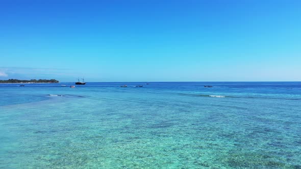 Luxury above clean view of a white paradise beach and turquoise sea background in colorful 4K alt