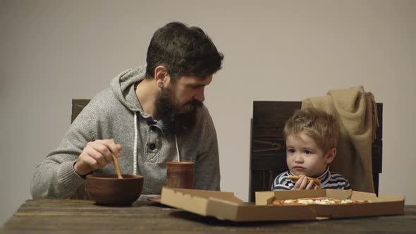 Dad and Kid Eating Pizza alt