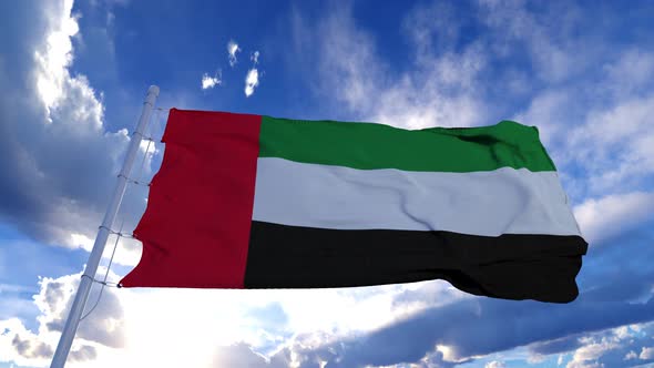 Realistic Flag of United Arab Emirates Waving at Wind in Slow with Blue Sky alt