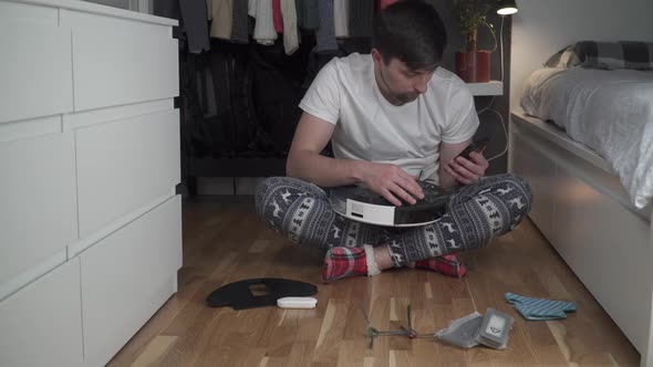 Young Caucasian Man Doing Cleaning for the Holiday Christmas in Winter alt