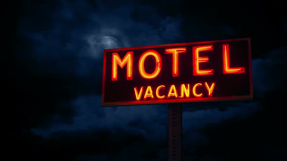 Moon Hidden In The Clouds Above Motel Sign alt