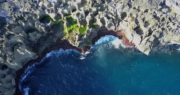 Aerial drone view of rocky tide pools coastline. alt