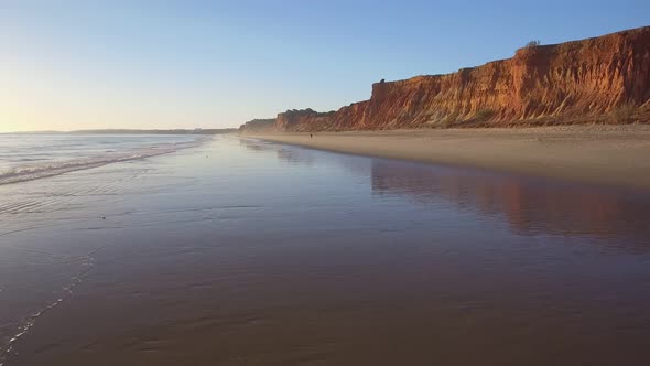 Aerial Flight Over a Beautiful Evening Beach at Low Tide and a Mirrored Surface That Reflects the alt