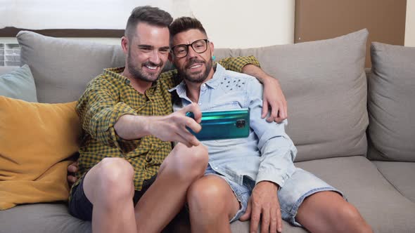 Young Smiling Gay Couple Taking Selfie at Home alt