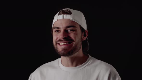 Trendy 20s Man excited, cheerful and happy gesture, close, black background alt