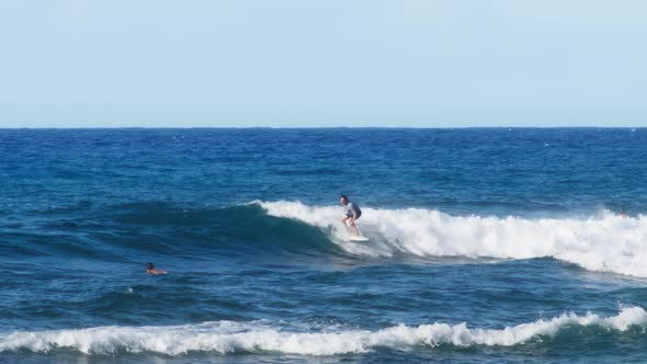Surfer Riding and Turning with Spray on Blue Ocean Wave on Hawaii Island Coast alt