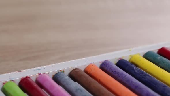 Colored Pastels For Drawing.  In Open Packaging. Slider Camera. Shooting Diagonally. Close Up.