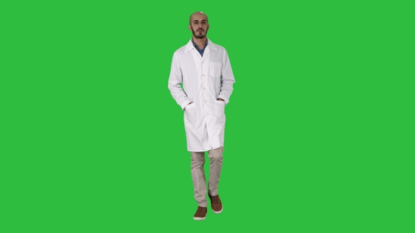 Arab handsome doctor wearing his uniform walking with hands alt
