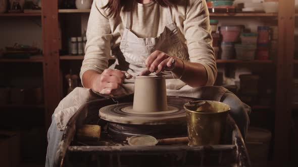 Pottery Workshop  Female Hands Cutting Off the Top Part of the Clay Pot Using a String alt