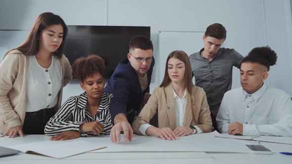 Designers Team Discussing Architectural Plan at Meeting alt