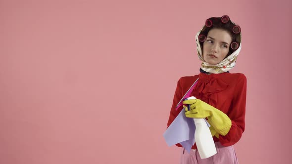 A Tired Young Female Housekeeper Looks at the Empty Space on the Left and Sighs