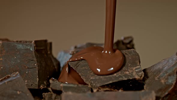 Super Slow Motion Shot of Pouring Melted Chocolate on Raw Chocolate Chunks at 1000 Fps alt