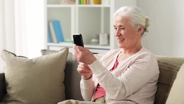Old Woman with Smartphone Having Video Chat  alt