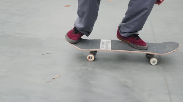 Skater Practicing in the Autumn Concrete Skate Park Making Tricks and Rides in Ramp alt