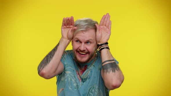 Lovely Funny Man Smiling Friendly Doing Bunny Ears Gesture on Head Having Fun Fooling Comical Mood alt