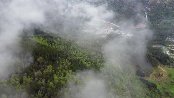Beautiful high altitude view through passing clouds of Kinsarvik hardanger - Rotating aerial passing alt