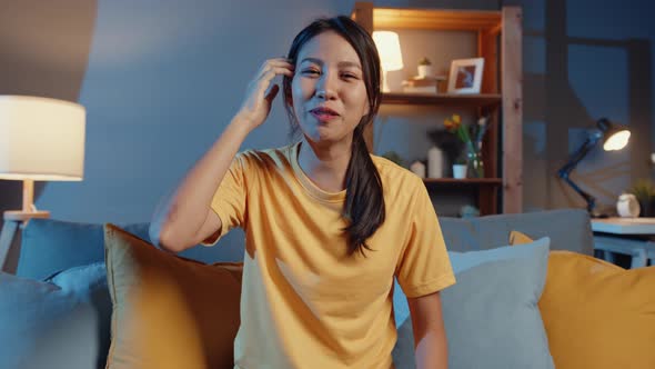 Happy young freelance asia woman looking at camera smile and talk with friend on video call online. alt