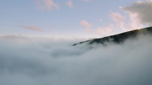 Aerial Drone Fly Over Misty Clouds in Mountains alt